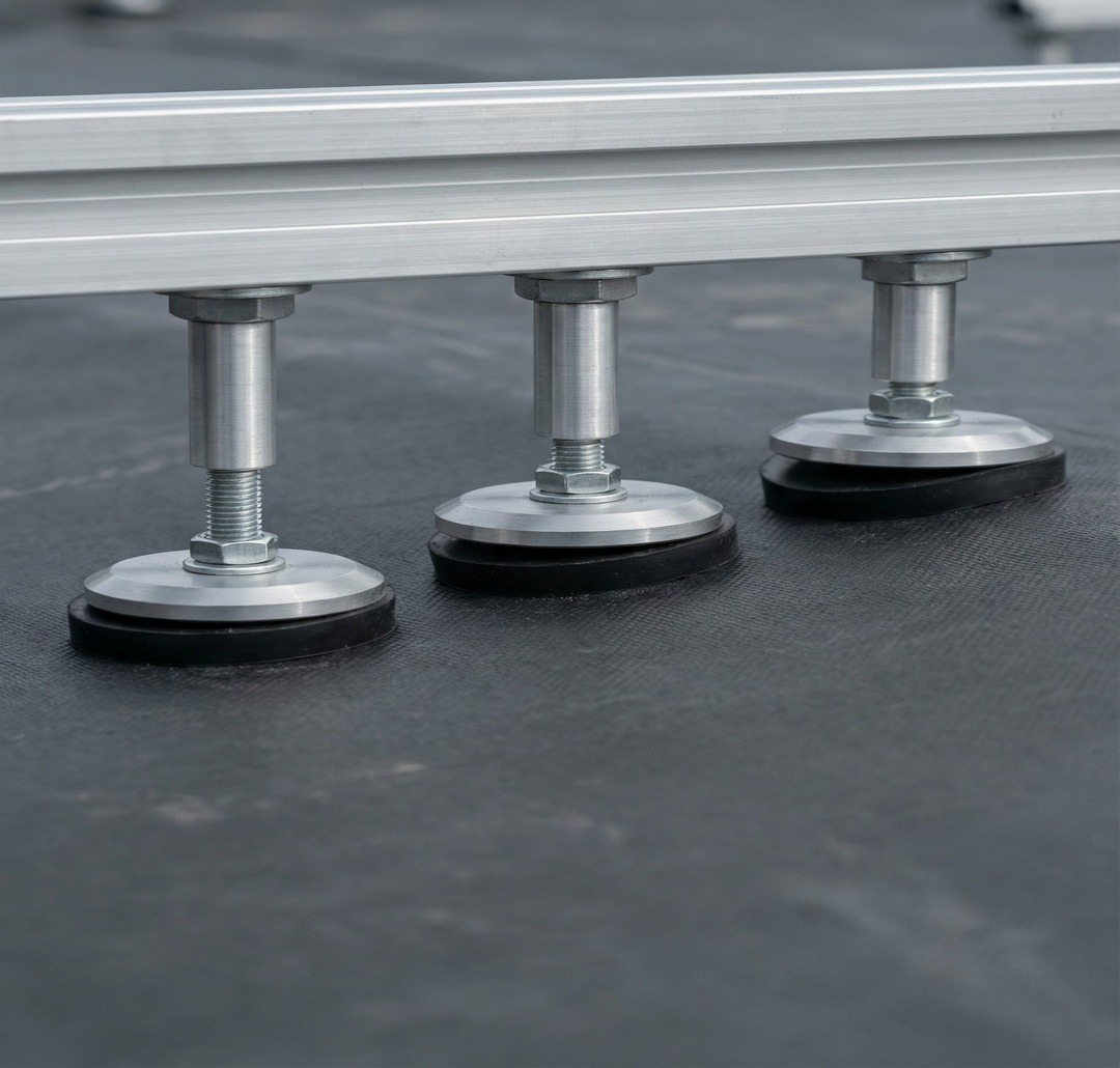 Adjustable BalcoDeck® pedestals levelling a deck on a flat roof